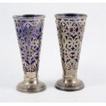 Pair of pierced silver tapering vases, with blue glass liners