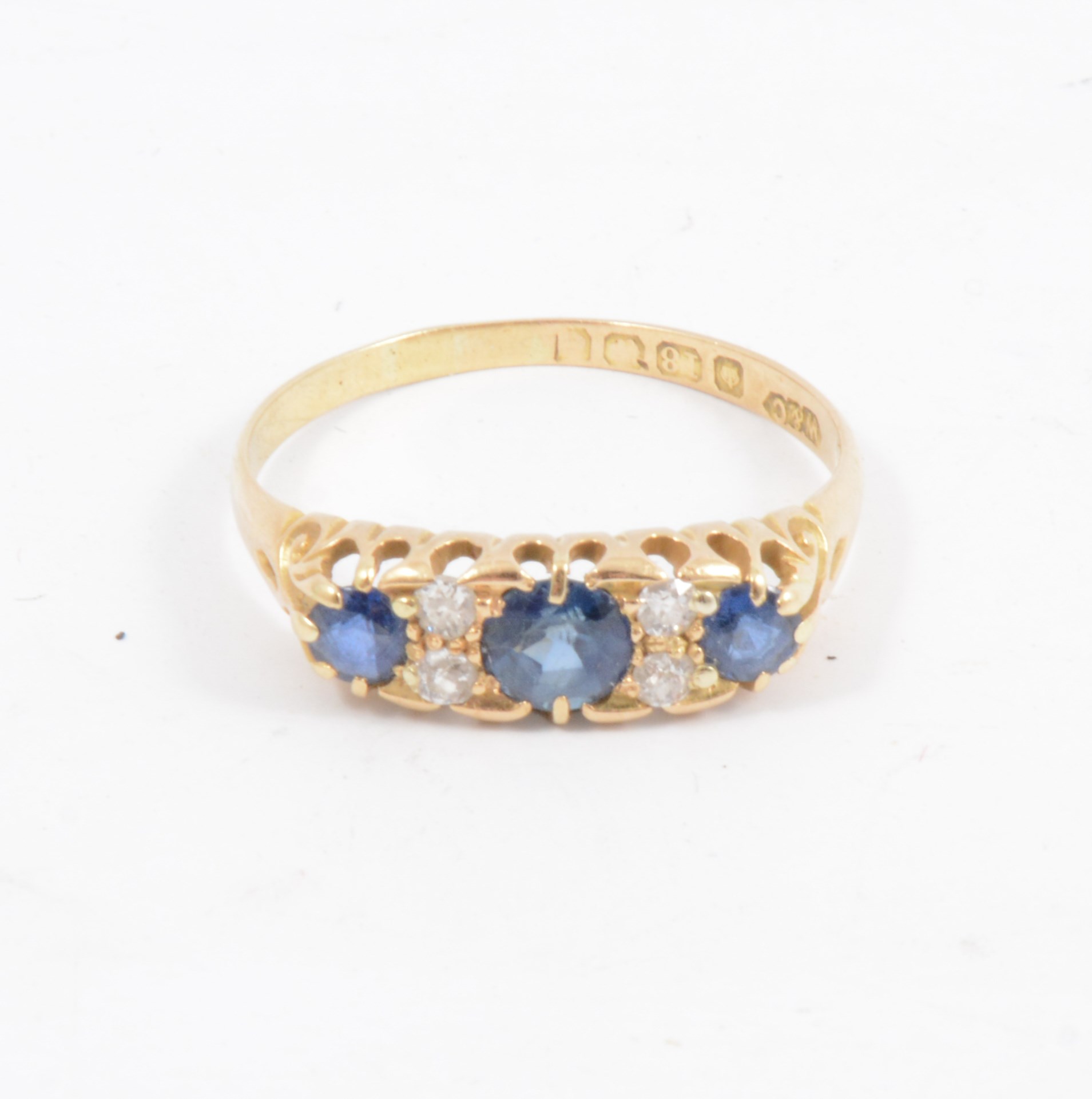 A sapphire and diamond half hoop ring, three sapphires spaced by two pairs of old cut diamonds in