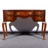 A walnut bowfront dressing table
