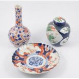 Chinese polychrome ginger jar; an Imari bottle vase; two Imari plates; and an Isnik style plate.