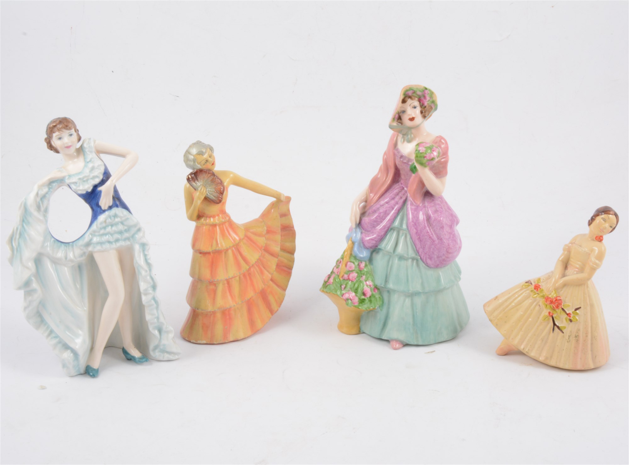 Twelve Crown Devon lady figurines, five in the art deco style and having "Sutherland Figures" paper