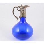 White metal mounted claret jug, with blown blue...