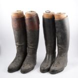 Two pairs of leather riding boots, both with wooden trees.