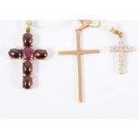 Three cross pendants, a 9 carat yellow gold cross, a diamond set cross, a plain cross and a fine