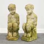 Two stone architectural figures of seated boys, reputedly from The Chester Arts College