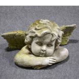 Concrete figure of a cherub, and another architectural fragment