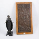 Three Christian statues and a relief plaque depicting the Madonna and Christ.