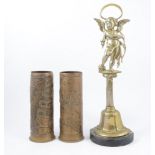 A pair of brass commemorative shell cases, and a brass doorstop.