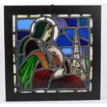 A stained glass panel of the Madonna and a church steeple originally from a a demolished church in