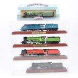 Sixteen model railway engine models on plinths and in plastic presentation cases,