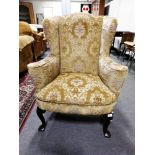 George III style wing back armchair, shaped arms, bowfront seat, cabriole legs, pad feet, 81cm.
