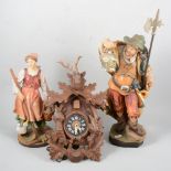 Cuckoo clock and two wooden figures.