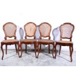 Set of four French stained beechwood dining chairs, cane panelled backs and seats, moulded