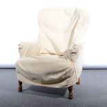 Edwardian nursing chair, blue upholstery under loose covers.