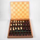 A modern resin chess set in the Chinese Imperial style in fitted wooden case with integral board
