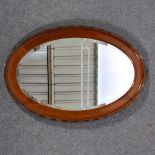 Oval oak framed mirror, bevelled plate, beaded edging.