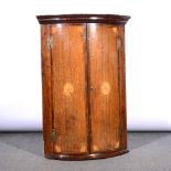 George III oak and mahogany cylinder front hanging corner cupboard.