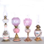 Four oil lamps, to include Hink's No.1, pink and clear glass banded globe with floral decoration,