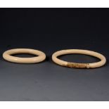 Two early 20th Century ivory bangles, monkey design.