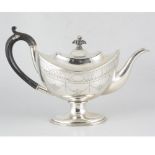 An oval silver teapot in the Adam style engraved with floral swags and bright cut borders on a