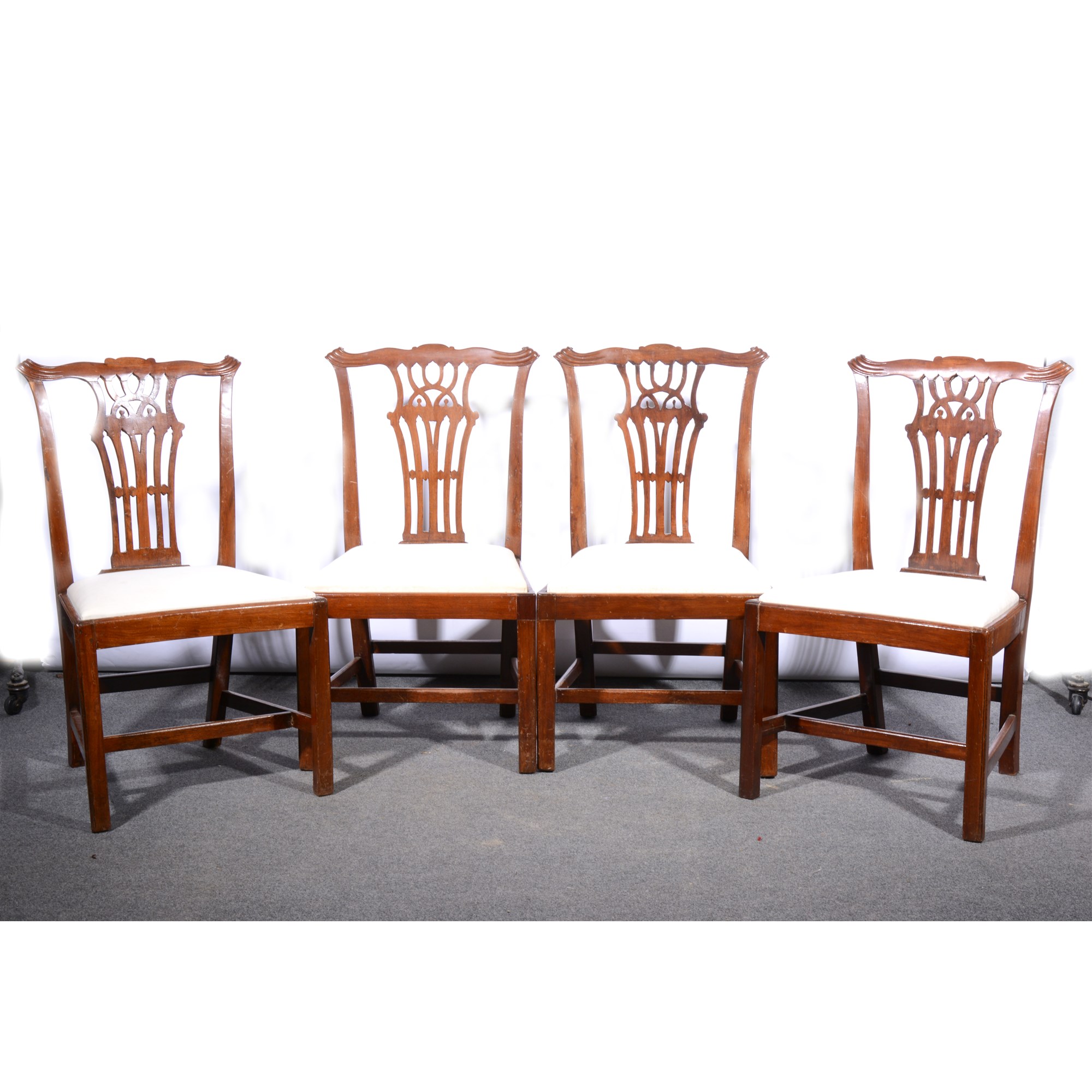 Set of six Chippendale style stained wood dining chairs.