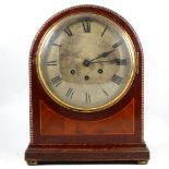 A mahogany mantel clock, domed top, strike and Westminster chime on a gong.