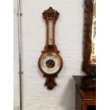 E Marston Loughborough an oak cased aneroid wall barometer with thermometer, carved scrolls to top