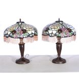 A pair of modern Tiffany style table lamps, bronze effect floral bases supporting glass shades