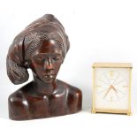 A Garrard desk clock, carved wooden female bust, brass jam pan, toasting fork and a carpet beater.