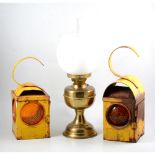 Three yellow enamelled Chalwyn road lamps and a brass oil lamp (4).