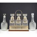 Quantity of moulded glass, including a gilt metal three bottle tantalus, 32cm,