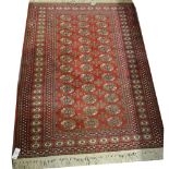 Bokhara rug, three rows of guls on a red field, muti-bordered, 176cm x 127cm.