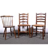 Two ash and stained wood ladder-back dining chairs, with rush seats, and an elm and beechwood