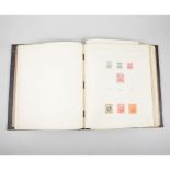 Stamp album: part filled with world stamps, pre 1920