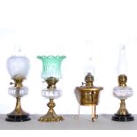 Four oil lamps, to include Hink's No. 2, green wrythen fluted shade, clear transparent reservoir,