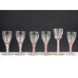 Collection of six wine glasses, rounded funnel bowl, ruby and opaque twist stems.