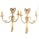 Set of four French Empire inspired gilt metal two-light wall sconces (some damage).
