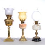 Three oil lamps, to include Hink's & Sons, almost opaque shade, brass reservoir with fluted top,