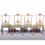 A set of four Edwardian stripped walnut salon chairs.