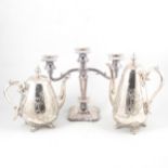 A four-piece silver plated tea set, three-light candlestick, other plated ware and silver napkin