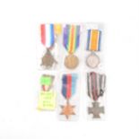 Assorted 20th century military medals and cap badges.