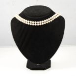 A two row non-graduated cultured pearl necklace, (49) (53), 6.5mm pearls, knotted every pearl into