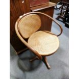 A Thonet bentwood swivel chair, with cane seat and back, width 57cm.