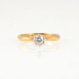 A diamond solitaire ring, the brilliant cut stone illusion set in a yellow and white metal mount