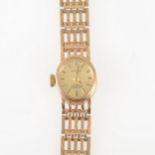 Rotary - a lady's 9 carat yellow gold bracelet watch, oval dark champagne baton dial in a 9 carat