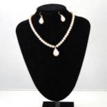 A cultured pearl and diamond necklace and earring suite, fifty-five 6.5/7mm pearls knotted every