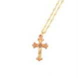 A rose metal cross, 25mm, marked 9ct on a modern 9 carat yellow gold twisted flat curb link chain