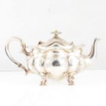 An Edwardian silver bachelor tea pot by Henry Williamson Ltd, of lobed oval form, embossed floral