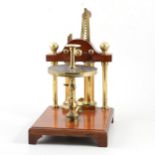 A 19th century two cylinder vacuum pump, mahogany, lacquered brass and glass.