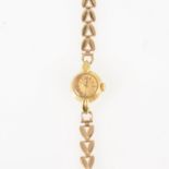 Doxa - a lady's gold bracelet watch, circular dark champagne baton dial in an 18 carat yellow gold